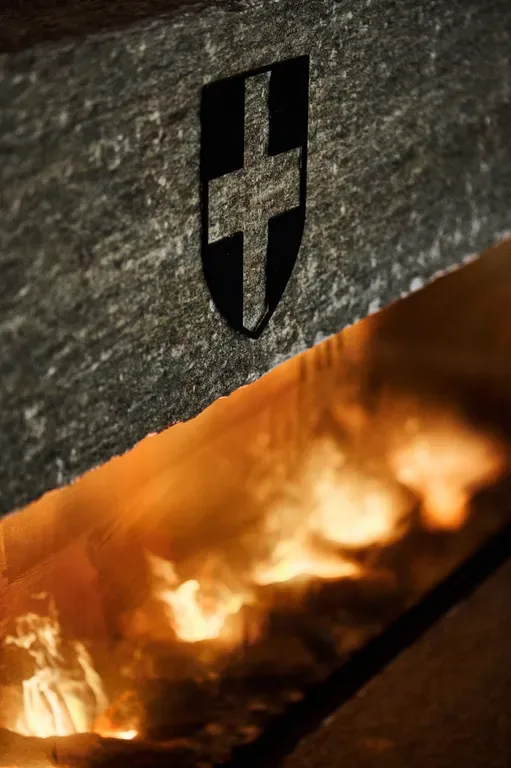 The carved crest on the fireplace